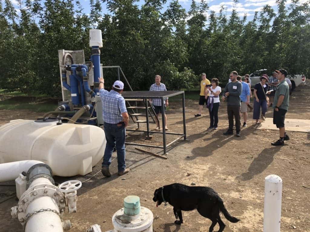 Equipment demonstration in orchard. 