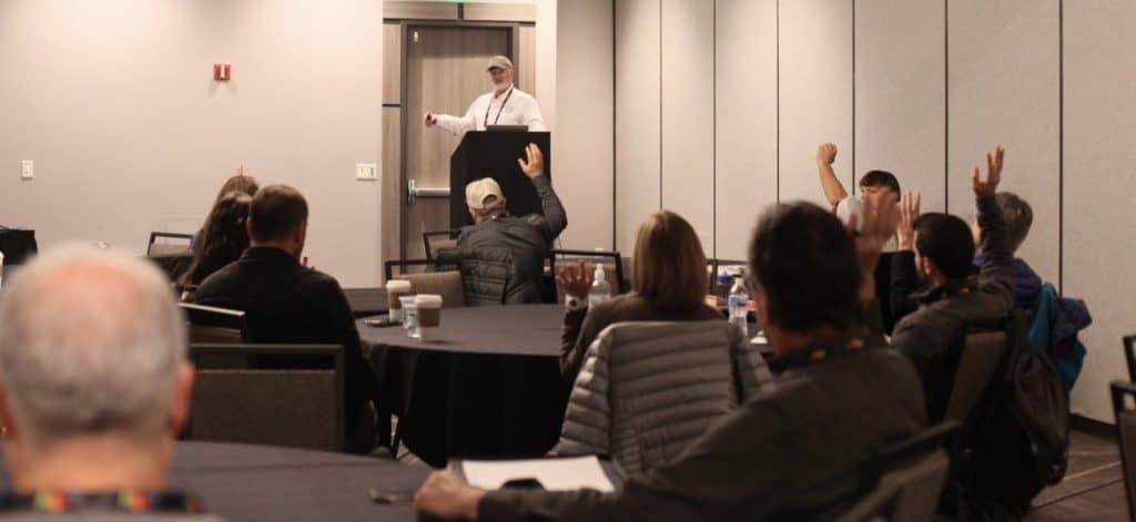 Attendees raise hands, Mark Shepard teaches Eco-Ag U workshop